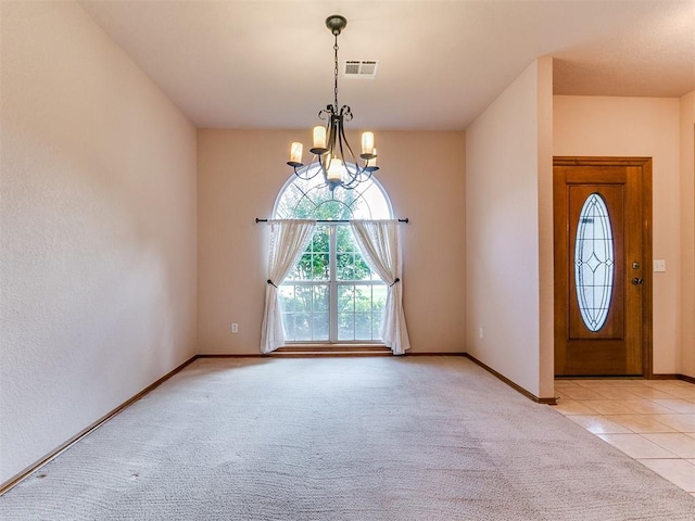 1204 Scrambler Ln, Edmond, OK 73025 - foyer featuring a chandelier, light colored carpet, and light tile patterned flooring