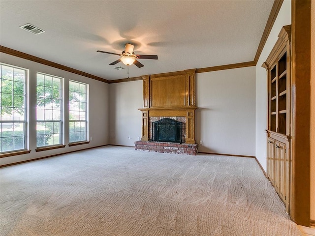 1204 Scrambler Ln, Edmond, OK 73025 - unfurnished living room featuring ornamental molding, light carpet, a brick fireplace, ceiling fan, and a textured ceiling