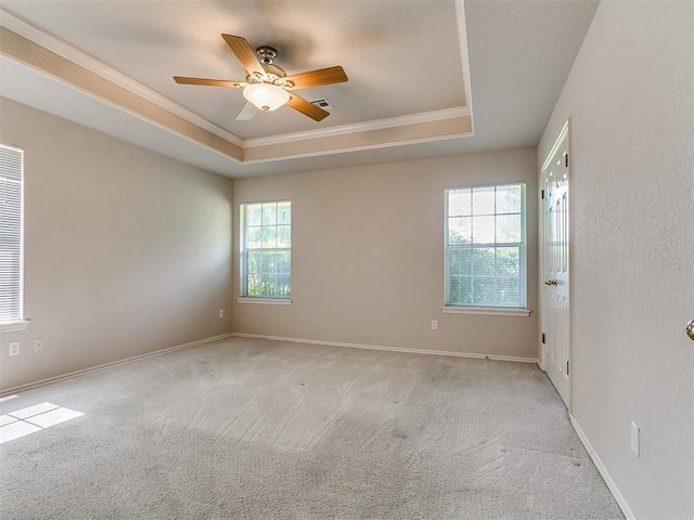 1204 Scrambler Ln, Edmond, OK 73025 - carpeted empty room featuring ornamental molding, a tray ceiling, and ceiling fan