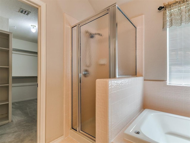 1204 Scrambler Ln, Edmond, OK 73025 - bathroom with a stall shower, a walk in closet, and a bath
