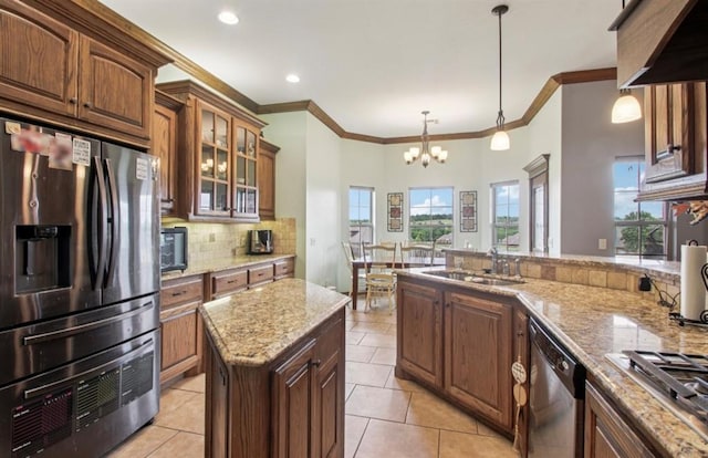 7732 Jesse Trl, Oklahoma City, OK 73150 - kitchen with appliances with stainless steel finishes, a chandelier, backsplash, ornamental molding, and light tile patterned flooring
