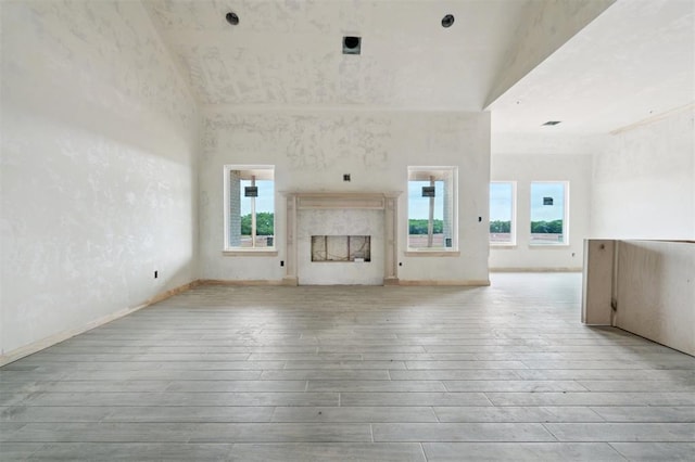 41364 Hazel Dell Rd, Shawnee, OK 74804 - unfurnished living room featuring wood-type flooring, plenty of natural light, and a premium fireplace