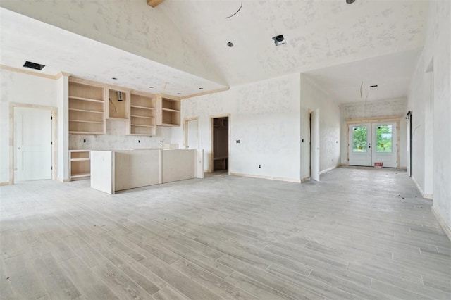41364 Hazel Dell Rd, Shawnee, OK 74804 - unfurnished living room featuring high vaulted ceiling, light wood-style floors, and french doors