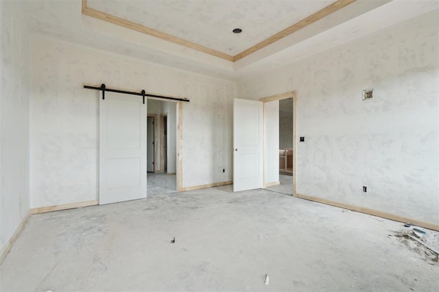 41364 Hazel Dell Rd, Shawnee, OK 74804 - unfurnished bedroom featuring unfinished concrete flooring, crown molding, a barn door, and a tray ceiling