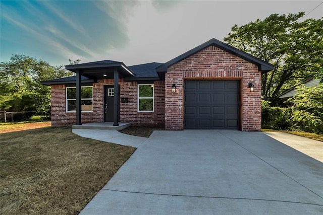 1417 Mallard Dr, Del City, OK 73115 - ranch-style house featuring concrete driveway, brick siding, an attached garage, and a front yard