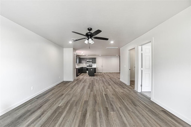1417 Mallard Dr, Del City, OK 73115 - unfurnished living room featuring wood finished floors, recessed lighting, and ceiling fan