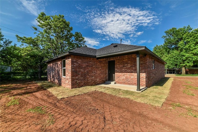 1417 Mallard Dr, Del City, OK 73115 - view of side of property featuring brick siding and roof with shingles