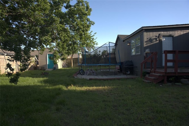 9008 N Walker Ave, Oklahoma City, OK 73103 - view of yard with a trampoline and a storage shed