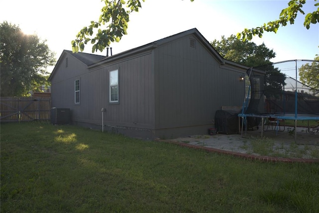 9008 N Walker Ave, Oklahoma City, OK 73103 - view of side of home featuring a trampoline and a central air condition unit