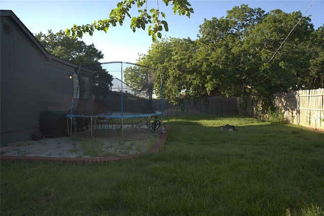 9008 N Walker Ave, Oklahoma City, OK 73103 - fenced backyard with a trampoline and a patio