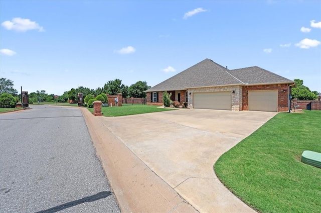 641 Geneva Dr, Edmond, OK 73025 - view of front of home featuring a garage, driveway, brick siding, and roof with shingles