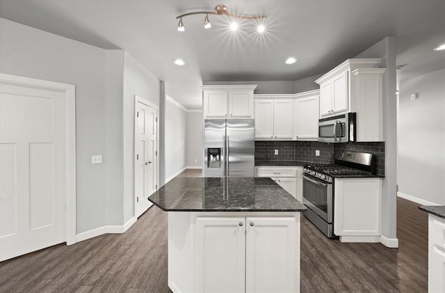 641 Geneva Dr, Edmond, OK 73025 - kitchen featuring stainless steel appliances, dark wood-style flooring, white cabinets, decorative backsplash, and a kitchen island
