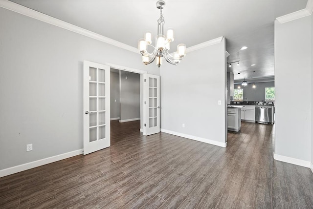 641 Geneva Dr, Edmond, OK 73025 - empty room with french doors, ornamental molding, a chandelier, and dark wood-type flooring