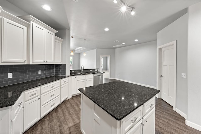 641 Geneva Dr, Edmond, OK 73025 - kitchen featuring dishwasher, dark wood-type flooring, recessed lighting, tasteful backsplash, and white cabinets