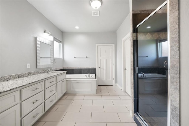 641 Geneva Dr, Edmond, OK 73025 - full bath featuring a garden tub, vanity, tile patterned flooring, and a shower stall