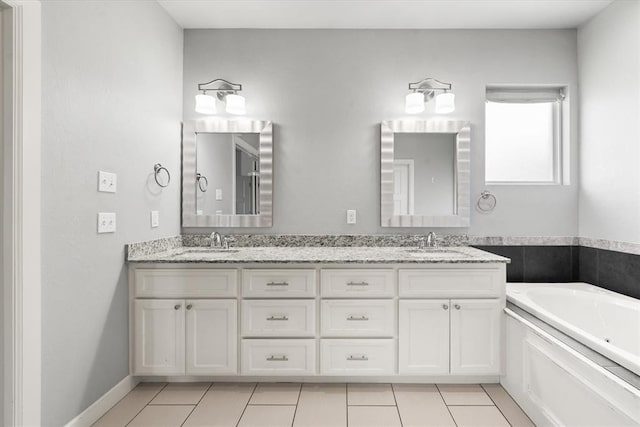 641 Geneva Dr, Edmond, OK 73025 - full bath featuring double vanity, a jetted tub, and tile patterned flooring