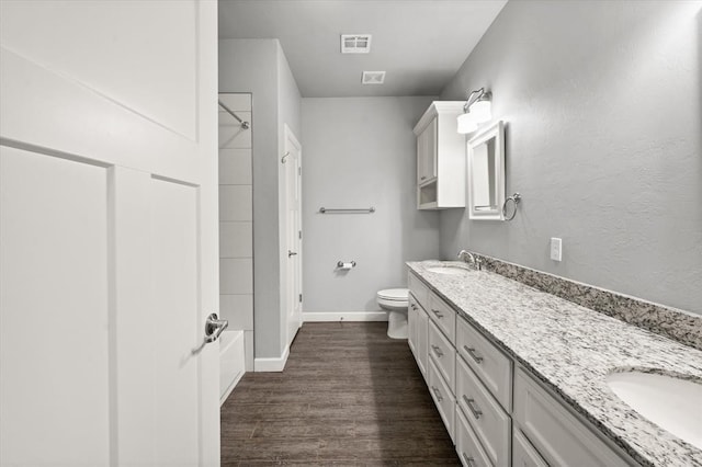 641 Geneva Dr, Edmond, OK 73025 - bathroom with double vanity, wood finished floors, and shower / bathtub combination