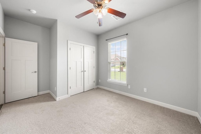 641 Geneva Dr, Edmond, OK 73025 - unfurnished bedroom featuring carpet, a closet, and ceiling fan