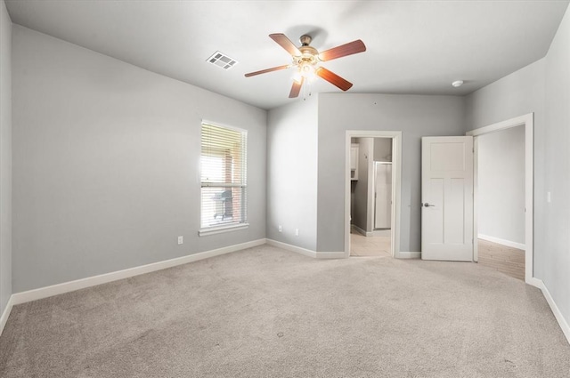 641 Geneva Dr, Edmond, OK 73025 - unfurnished bedroom with light colored carpet, ceiling fan, and connected bathroom