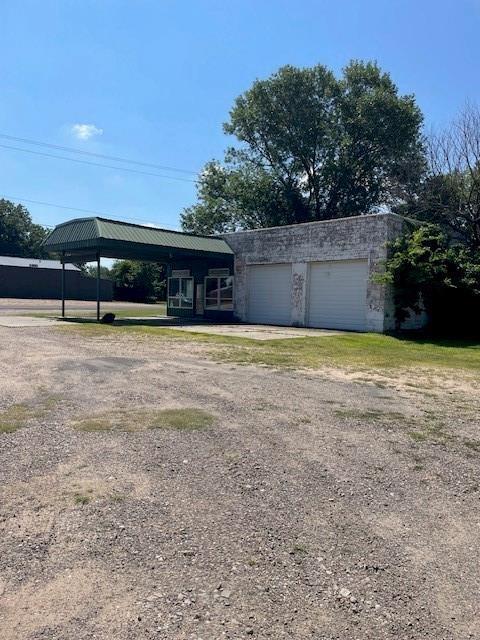 1403 W Columbia St, Okemah, OK 74859 - view of front of home with driveway, an attached garage, and a gazebo