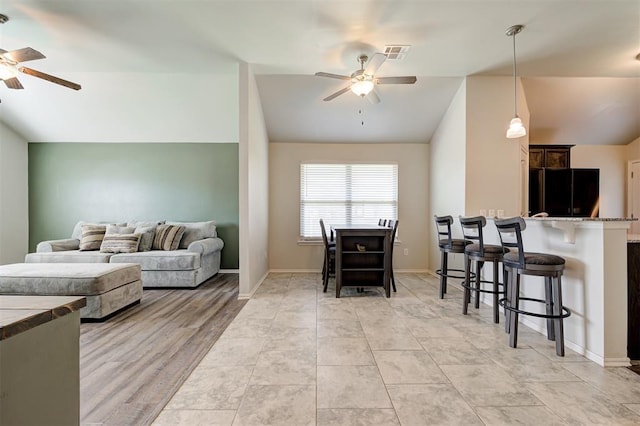 1109 Hickory Creek Dr, Yukon, OK 73099 - living room featuring a ceiling fan and lofted ceiling