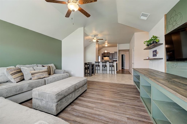 1109 Hickory Creek Dr, Yukon, OK 73099 - living area featuring a ceiling fan and vaulted ceiling