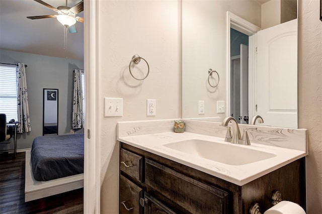 1109 Hickory Creek Dr, Yukon, OK 73099 - ensuite bathroom with vanity, wood finished floors, and a ceiling fan