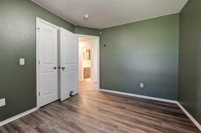 1109 Hickory Creek Dr, Yukon, OK 73099 - unfurnished bedroom with wood finished floors and baseboards