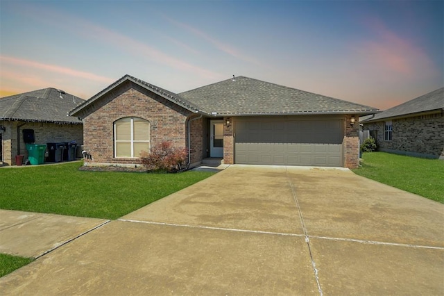 1109 Hickory Creek Dr, Yukon, OK 73099 - ranch-style home featuring brick siding, a front yard, an attached garage, and concrete driveway