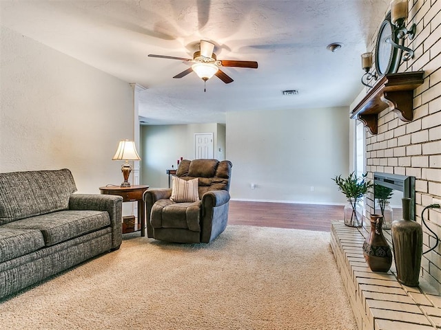 2349 Fox Ln, Blanchard, OK 73010 - living room with ceiling fan, a brick fireplace, and carpet flooring