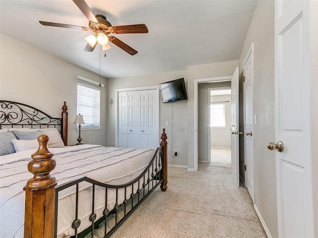 2349 Fox Ln, Blanchard, OK 73010 - bedroom with light carpet, multiple windows, a closet, and a ceiling fan