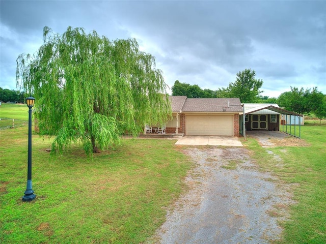 2349 Fox Ln, Blanchard, OK 73010 - view of front facade featuring driveway, a carport, a front lawn, an attached garage, and brick siding