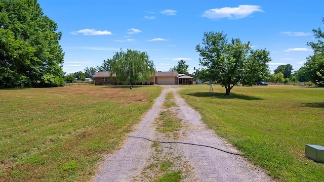 2349 Fox Ln, Blanchard, OK 73010 - view of front of property with dirt driveway, a front yard, and an attached garage