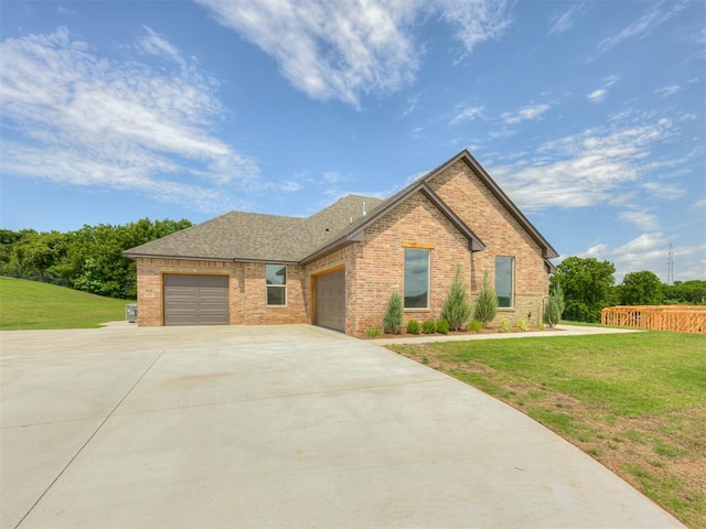 7625 Leoma Ln, Oklahoma City, OK 73150 - view of front of property featuring brick siding, an attached garage, driveway, and a shingled roof