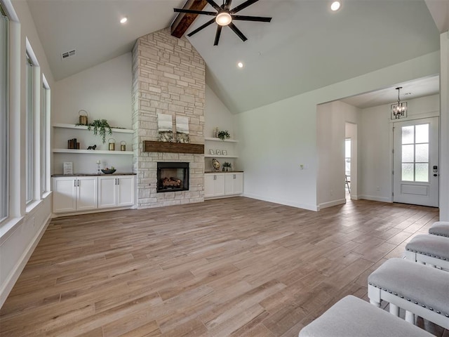 7625 Leoma Ln, Oklahoma City, OK 73150 - unfurnished living room featuring a ceiling fan, a chandelier, beam ceiling, high vaulted ceiling, and light wood-style flooring
