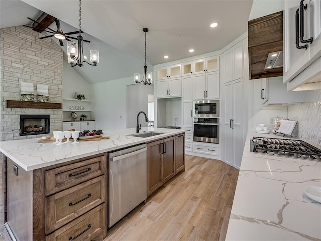 7625 Leoma Ln, Oklahoma City, OK 73150 - kitchen featuring appliances with stainless steel finishes, a chandelier, light wood-style flooring, white cabinetry, and custom range hood