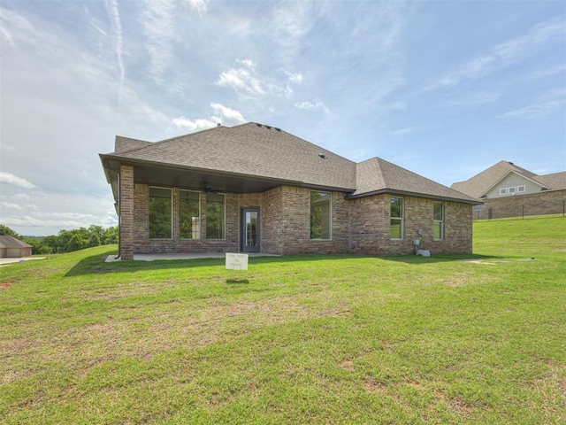 7625 Leoma Ln, Oklahoma City, OK 73150 - back of property featuring brick siding, a yard, and roof with shingles