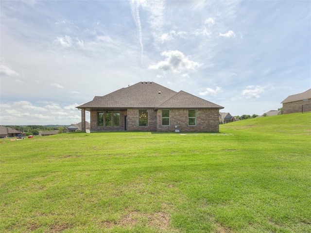 7625 Leoma Ln, Oklahoma City, OK 73150 - back of house with a lawn, roof with shingles, and brick siding