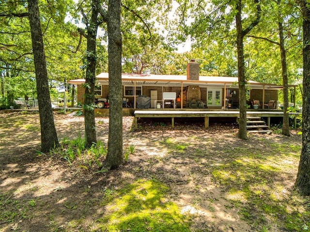 114 Timber Ln, Mcloud, OK 74851 - back of property featuring a chimney, a wooden deck, french doors, and brick siding