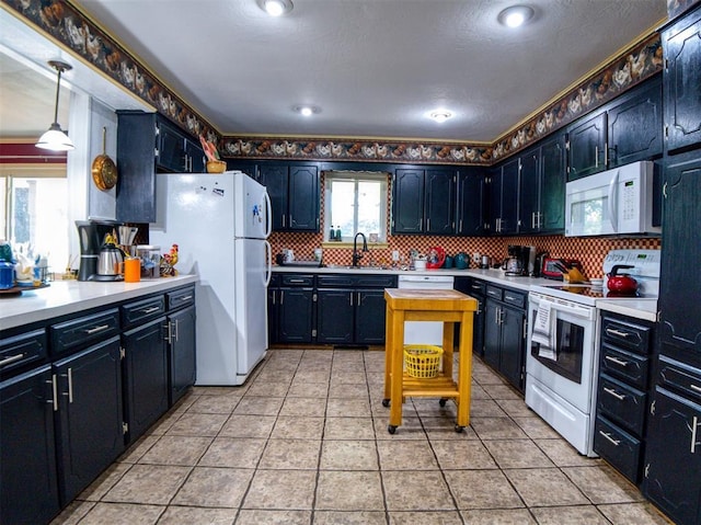 114 Timber Ln, Mcloud, OK 74851 - kitchen with white appliances, light countertops, and decorative backsplash