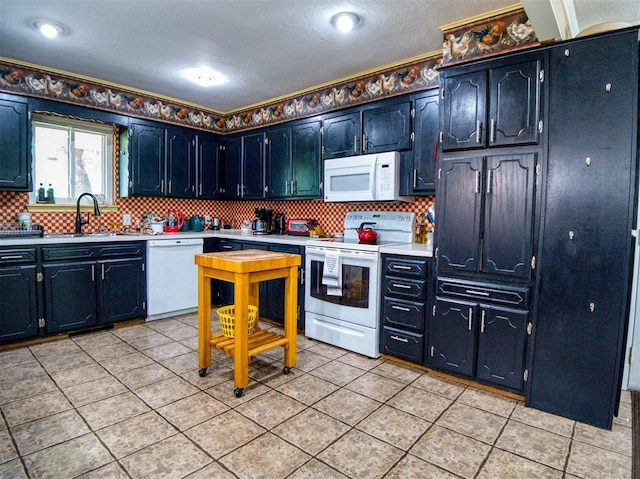 114 Timber Ln, Mcloud, OK 74851 - kitchen with white appliances, light countertops, tasteful backsplash, and light tile patterned flooring