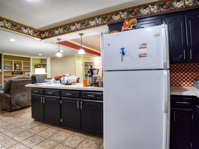 114 Timber Ln, Mcloud, OK 74851 - kitchen featuring freestanding refrigerator, light countertops, dark cabinetry, and light tile patterned flooring