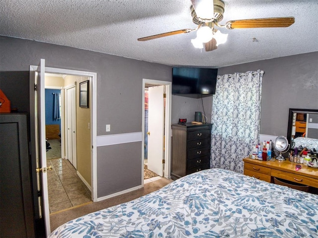 114 Timber Ln, Mcloud, OK 74851 - tiled bedroom featuring a textured ceiling, carpet flooring, and ceiling fan