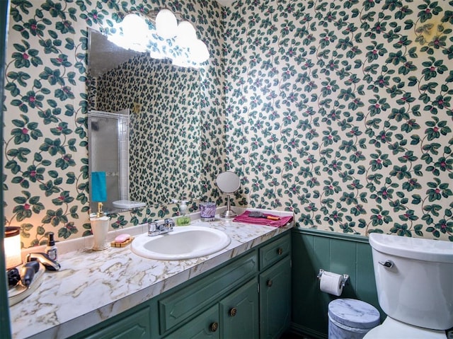 114 Timber Ln, Mcloud, OK 74851 - bathroom featuring wallpapered walls, vanity, a shower stall, and a wainscoted wall