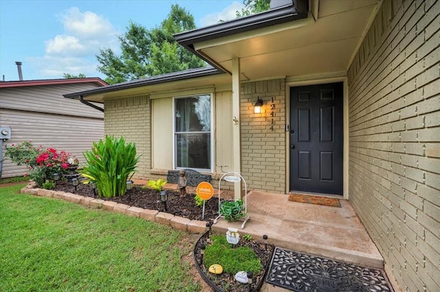 12414 SW 15th Ter, Yukon, OK 73099 - doorway to property with brick siding and a yard