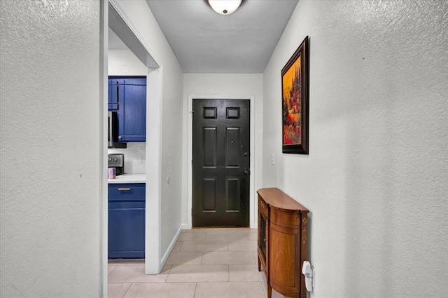 12414 SW 15th Ter, Yukon, OK 73099 - entrance foyer featuring light tile patterned floors and a textured wall