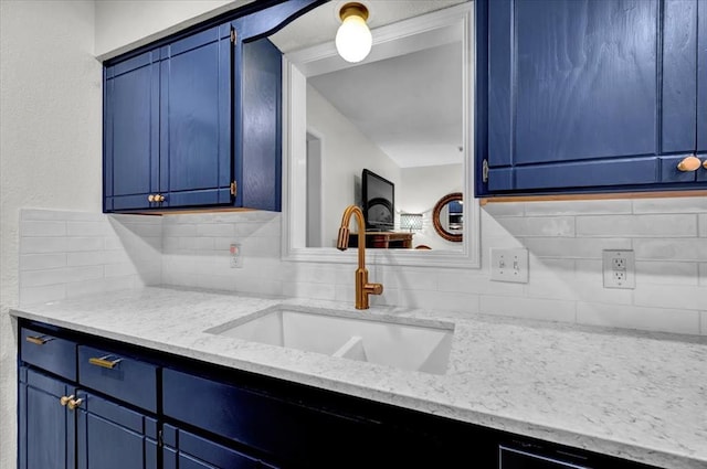 12414 SW 15th Ter, Yukon, OK 73099 - kitchen featuring blue cabinets, backsplash, and light stone countertops