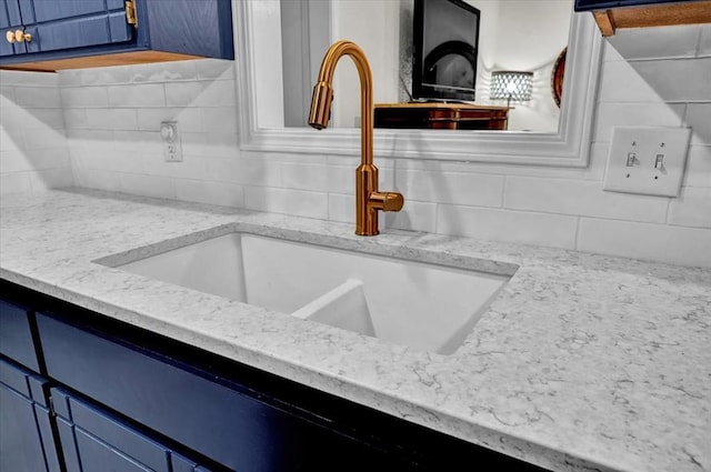 12414 SW 15th Ter, Yukon, OK 73099 - kitchen view of blue cabinets, decorative backsplash, and light stone countertops