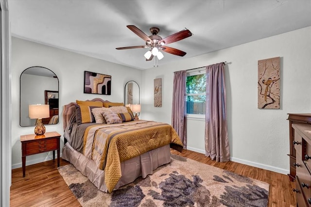 12414 SW 15th Ter, Yukon, OK 73099 - bedroom with wood finished floors and a ceiling fan
