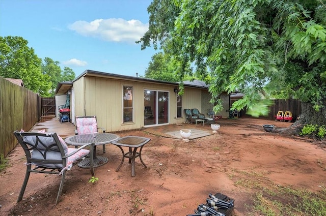 12414 SW 15th Ter, Yukon, OK 73099 - back of house with a fenced backyard and a patio area